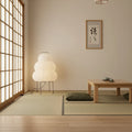 Japanese-style room with tatami mats, wooden table, and lamp.
