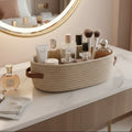 Cosmetic products on a marble vanity table with a round mirror.