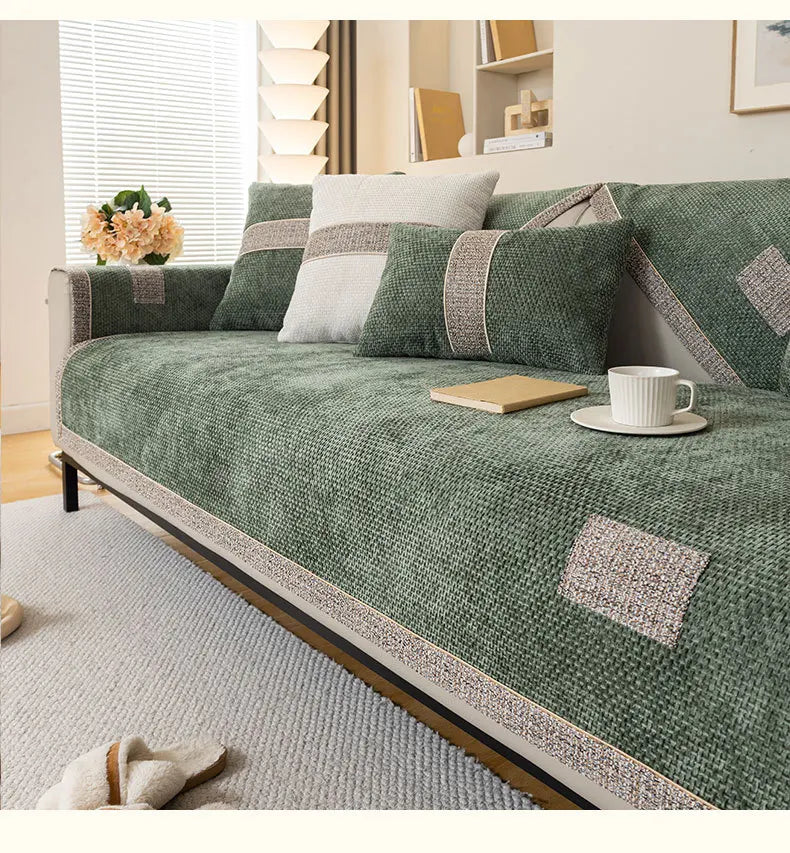 Green sofa with decorative cushions in a living room setting
