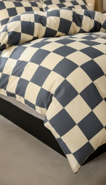 Checkered bedding with blue and white pattern on a bed.