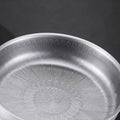 Tidings & Twinkle ForgeCore titanium frying pan with hammered non-stick design and peacock motif.